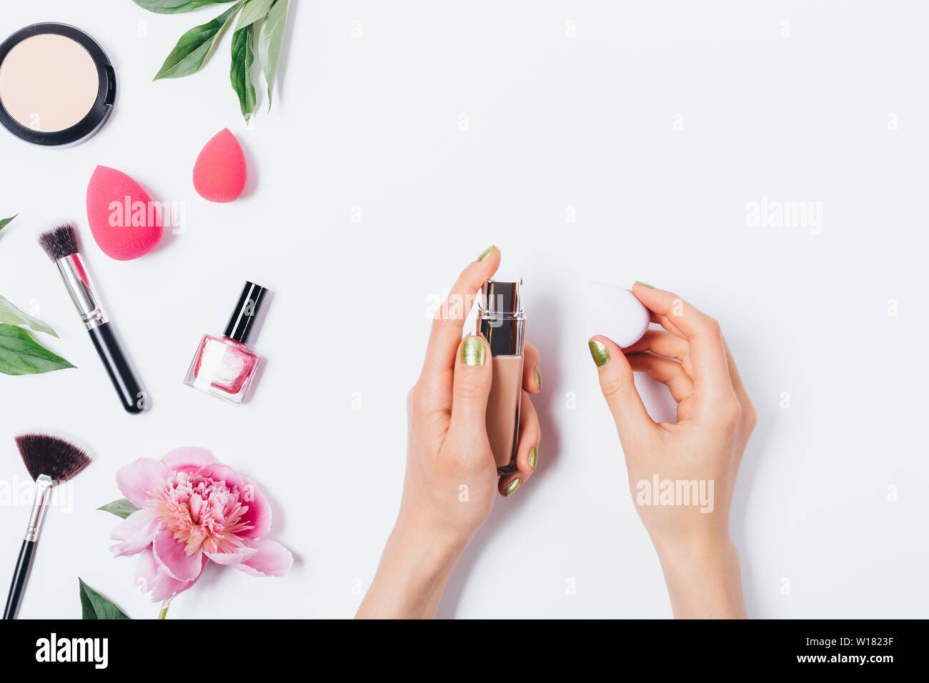 Woman’s hands holding makeup blending sponge applicator and facial 