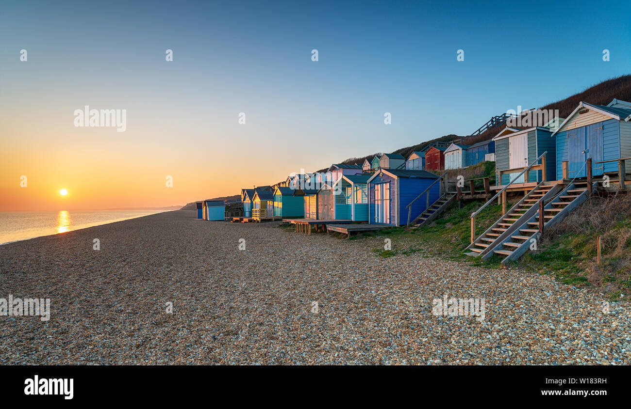 Rows of beach huts at Milford on Sea on the Hampshire coast Stock Photo
