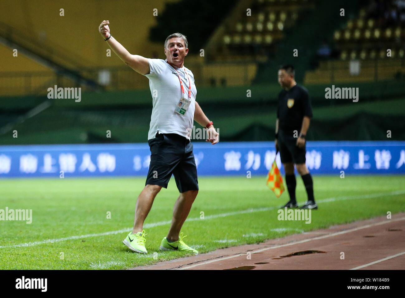 Head coach Dragan Stojkovic of Guangzhou R&F celebrates as he watches his players scoring against Henan Jianye in their 15th round match during the 2019 Chinese Football Association Super League (CSL) in Guangzhou city, south China's Guangdong province, 29 June 2019. Guangzhou R&F defeated Henan Jianye 2-0. Stock Photo