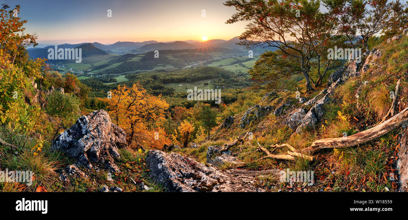 Panorama of sunset in a Carpathian mountain valley with wonderful gold light on a hills Stock Photo