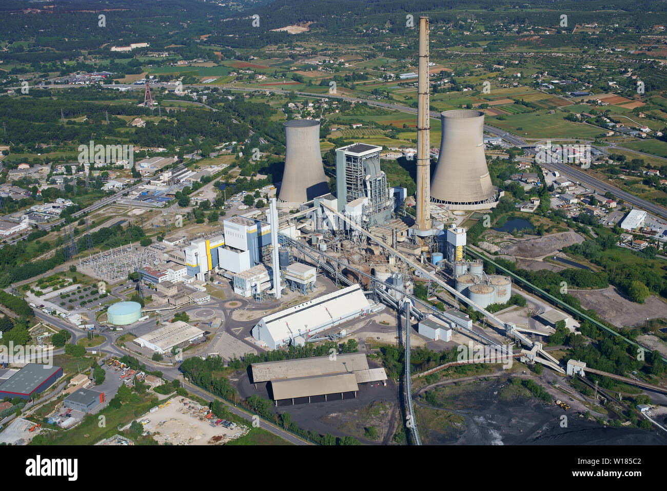 AERIAL VIEW. Large coal-fired thermal power station. At 297m high, this is the tallest chimney in France (as of 2019). Gardanne, Provence, France. Stock Photo