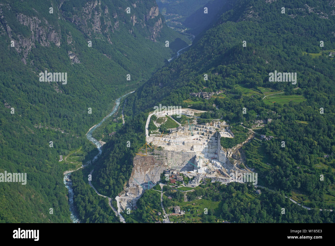 AERIAL VIEW. Large marble quarry at the entrance of the Val Divedro. Crevoladossola, Province of Verbano-Cusio-Ossola, Piedmont, Italy. Stock Photo