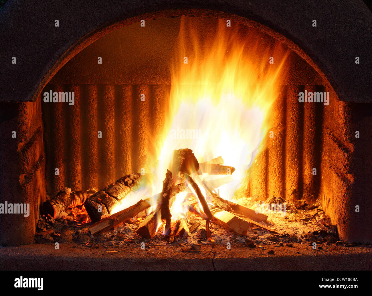 Fireplace with fire at night - outdoor shot Stock Photo