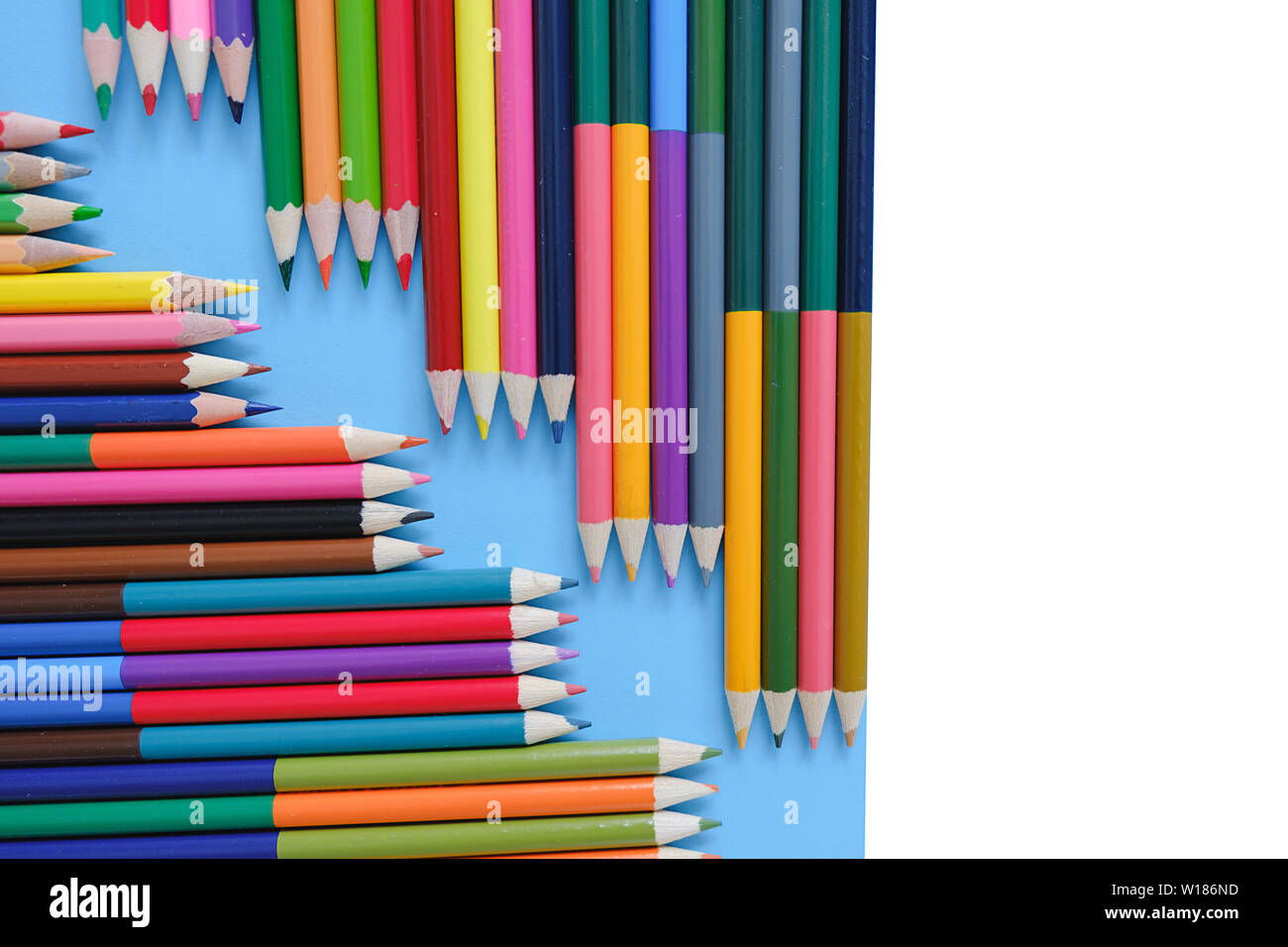 Creative flat lay back to school concept with colored pencils on blue ...