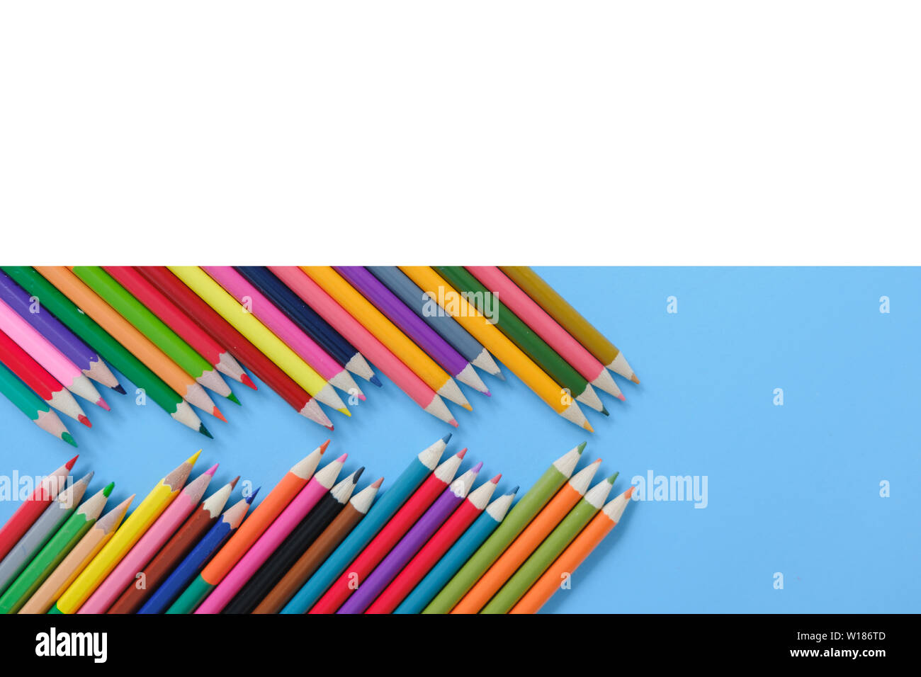 Creative flat lay back to school concept with colored pencils on blue ...