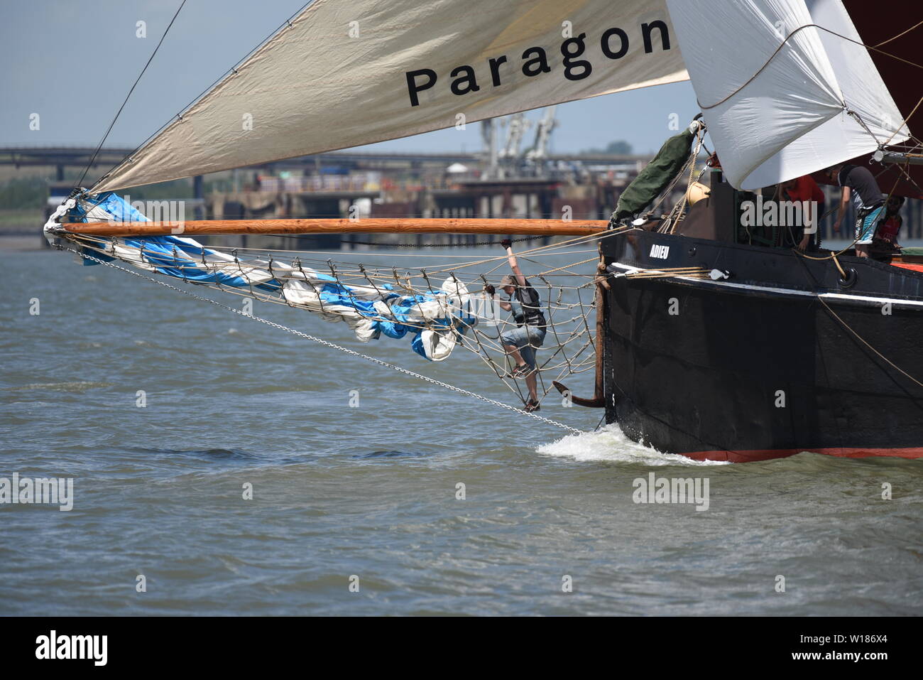 To gain extra speed, Adieu's crew deploy the jib from the bowsprit. Stock Photo