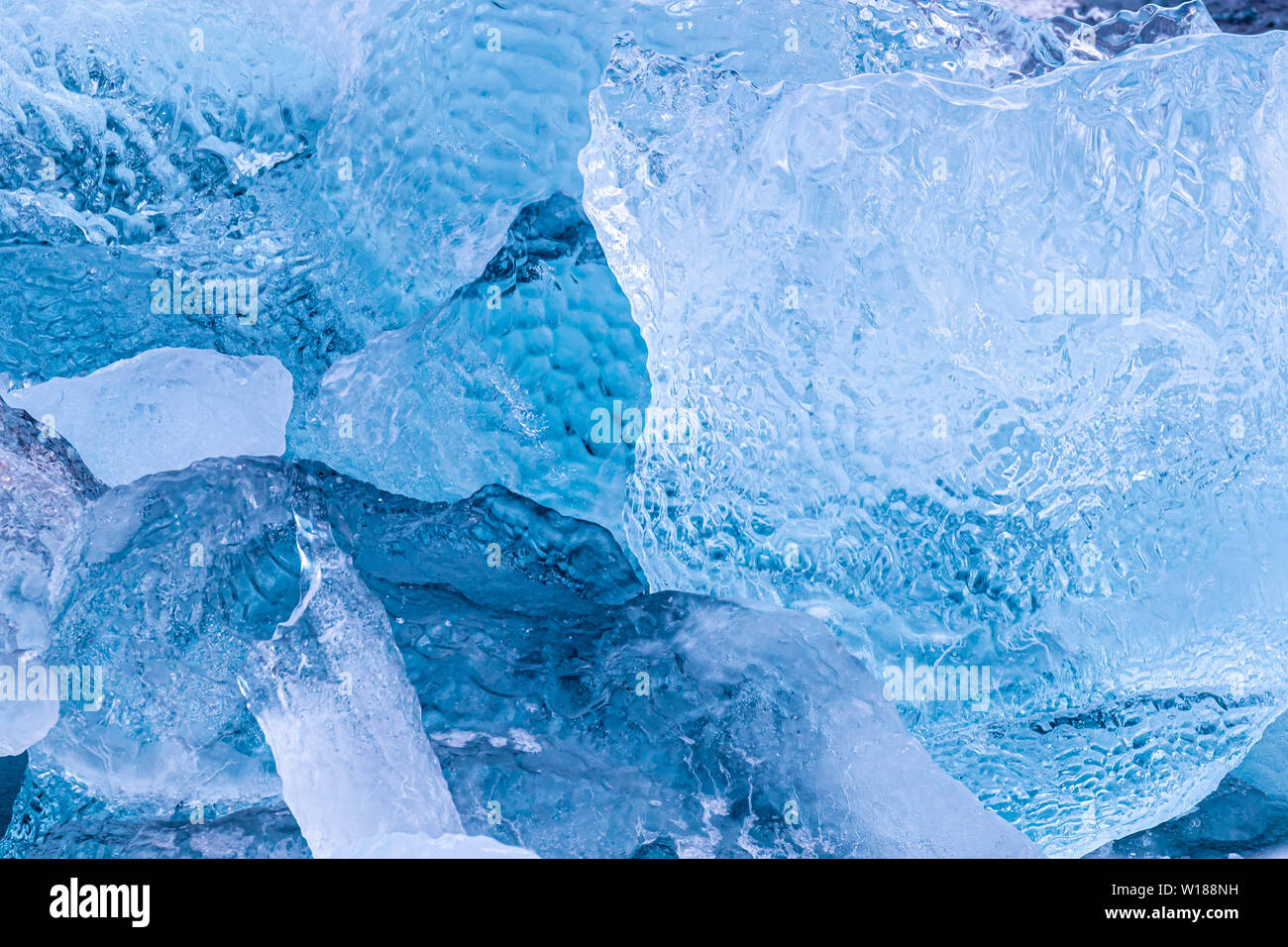 Details of iceberg fragments floating in the arctic sea. Blue glacial ice calved from the g;aciers of Svalbard, a Norwegian archipelago between mainla Stock Photo