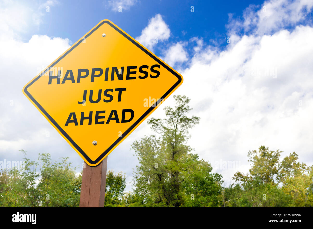 Happiness just ahead conceptual road sign Stock Photo