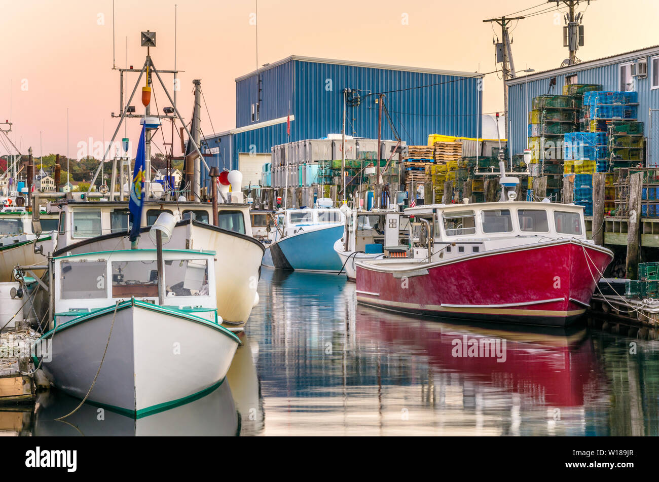 Colourful fishing boats moored in harbourt at twilight Stock Photo