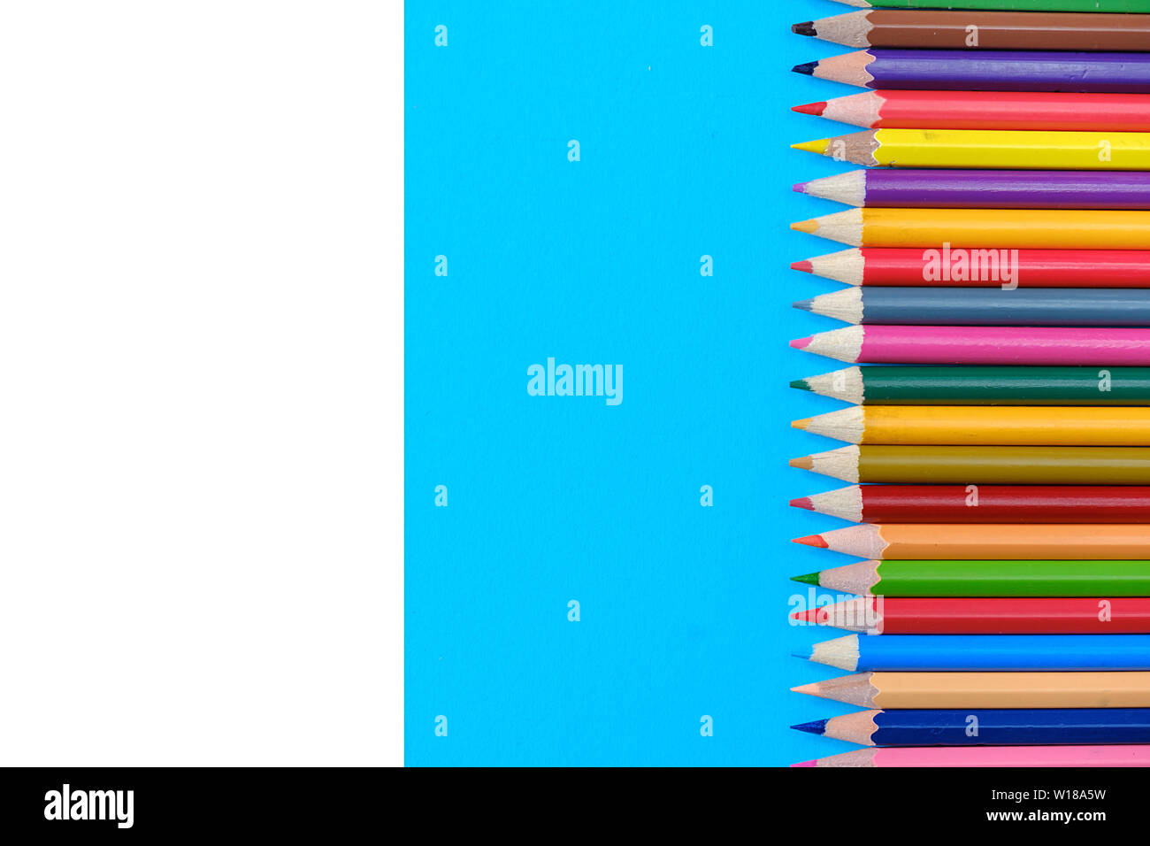 Creative flat lay back to school concept with colored pencils on blue ...
