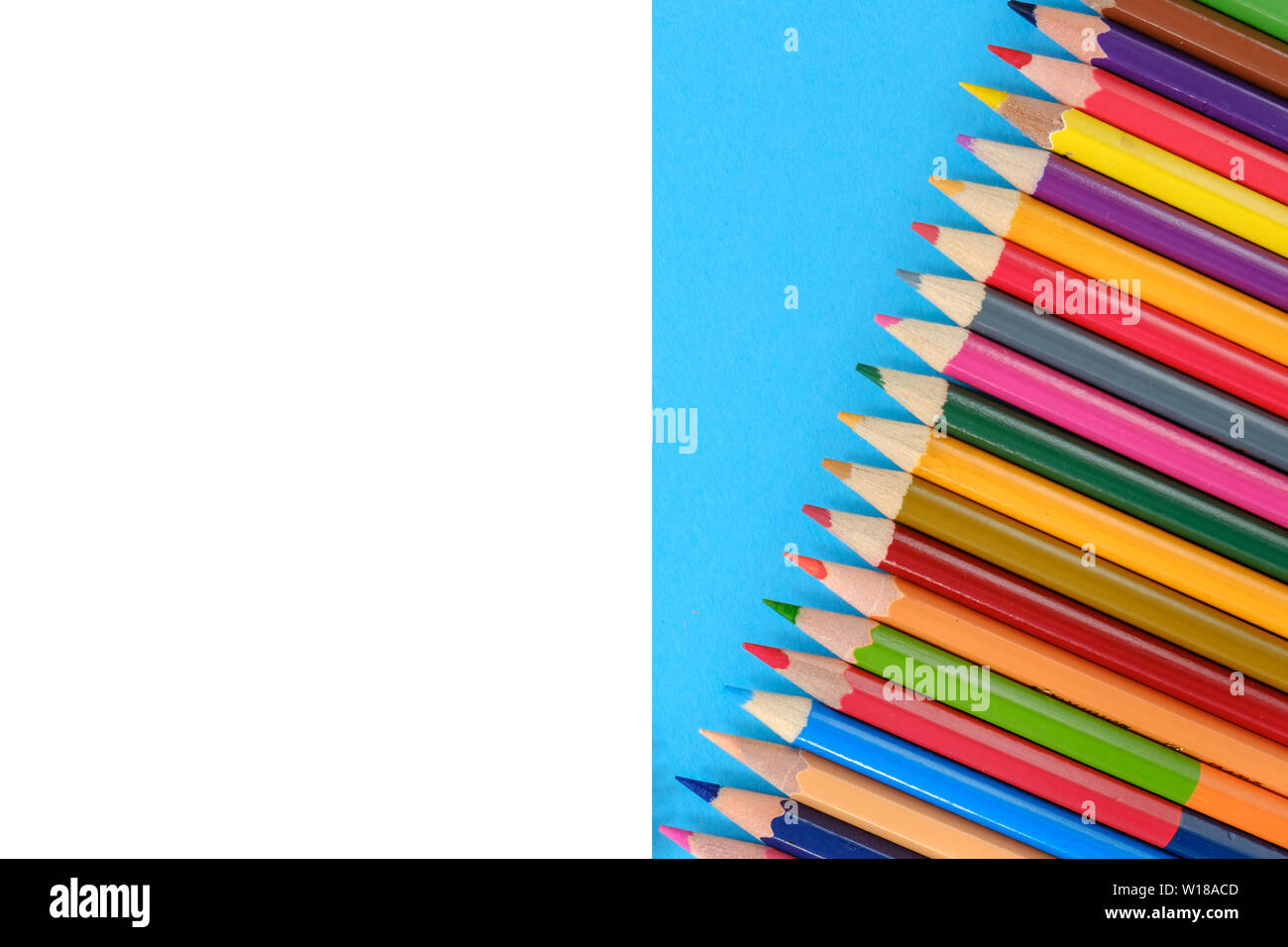 Creative flat lay back to school concept with colored pencils on blue ...