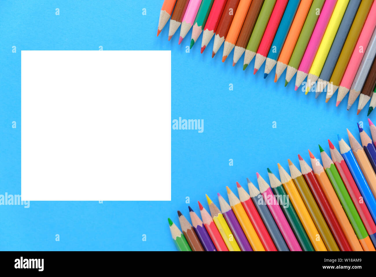 Creative flat lay back to school concept with colored pencils on blue ...