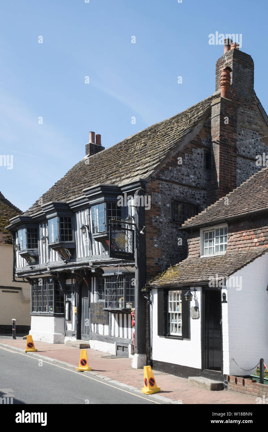 fine old buildings and pubs line the high street in the village of ...