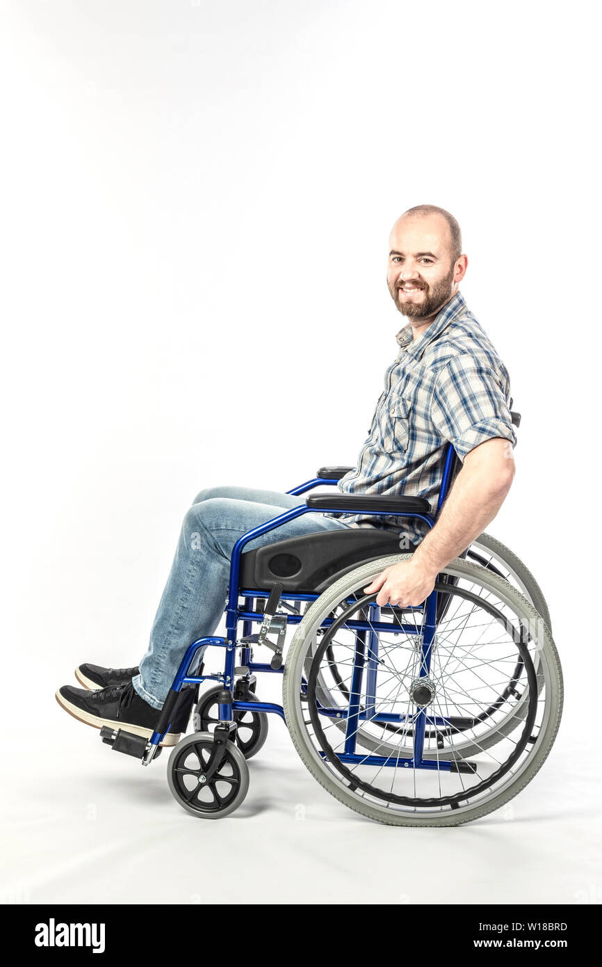 Caucasian man smiling and positive expression, disabled on wheelchair and white background. Stock Photo