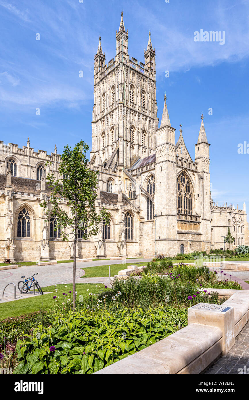 Gloucester Cathedral from the south with its beautifully carved and decorated 15th C tower and the Cathedral Green relandscaped in 2018, Gloucester UK Stock Photo
