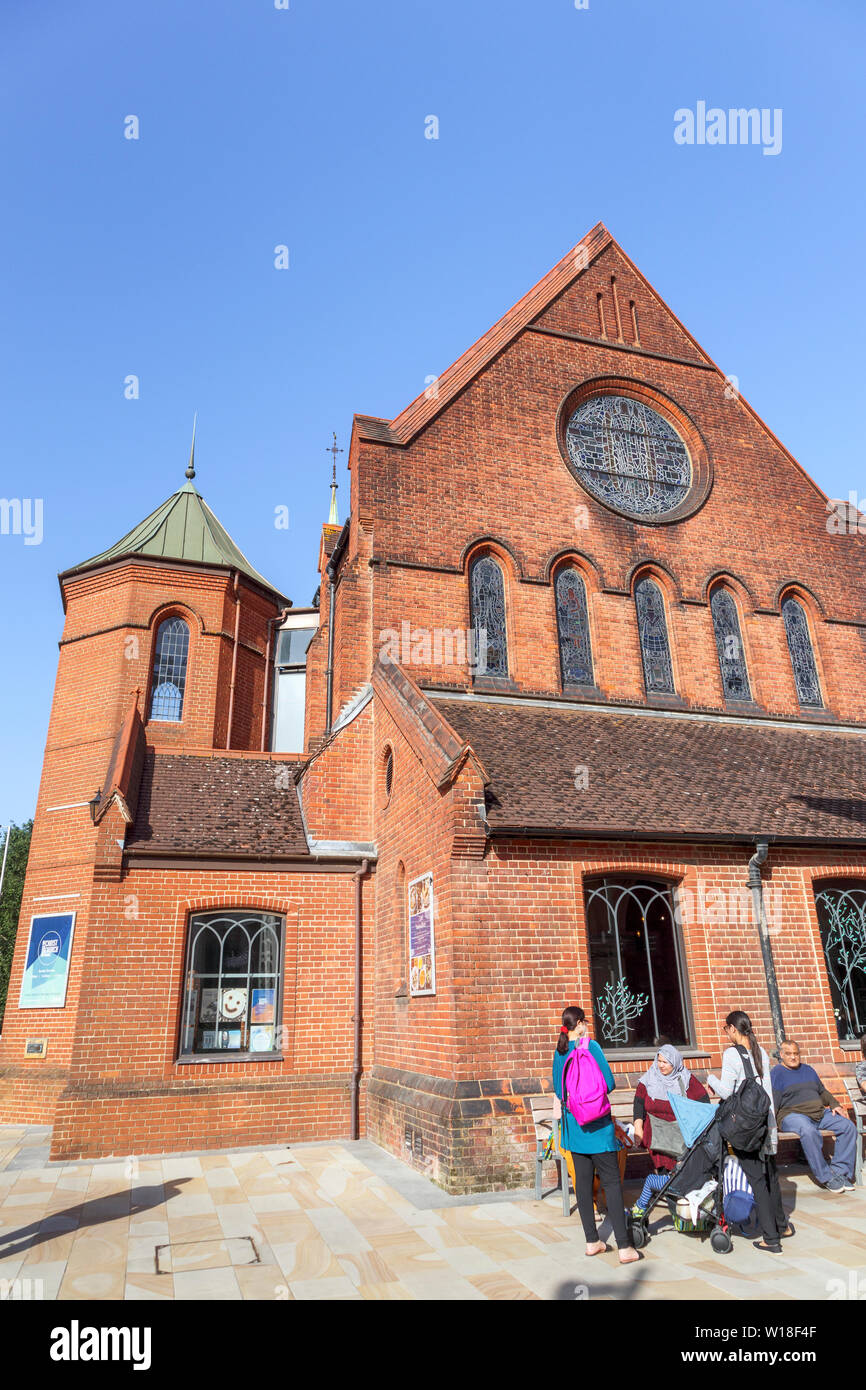 Front view of redbrick Christ Church in Jubilee Square in the town centre of Woking, Surrey, south-east England, on a sunny summer day, clear blue sky Stock Photo