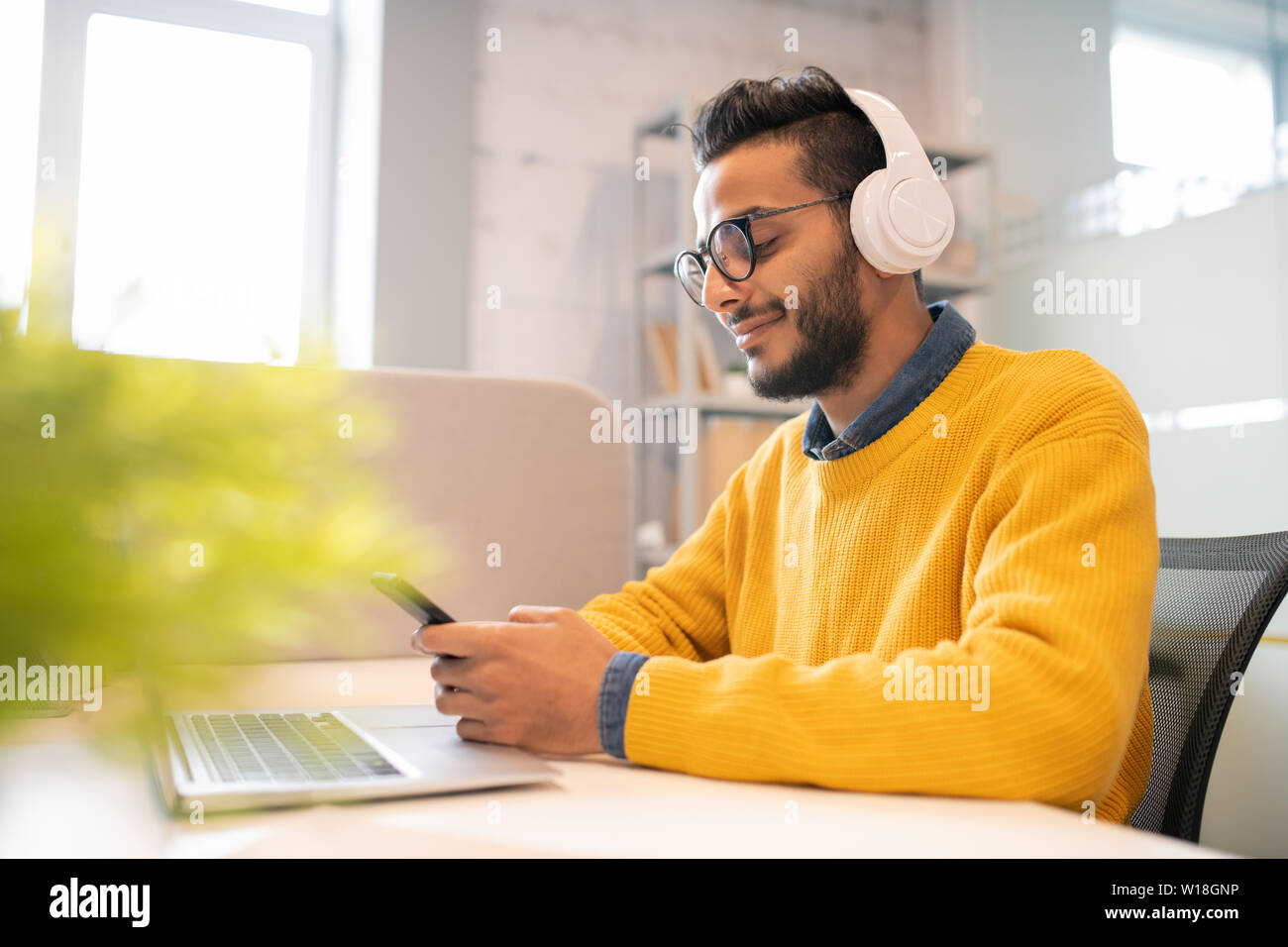 Satisfied young man sitting hi-res stock photography and images - Alamy