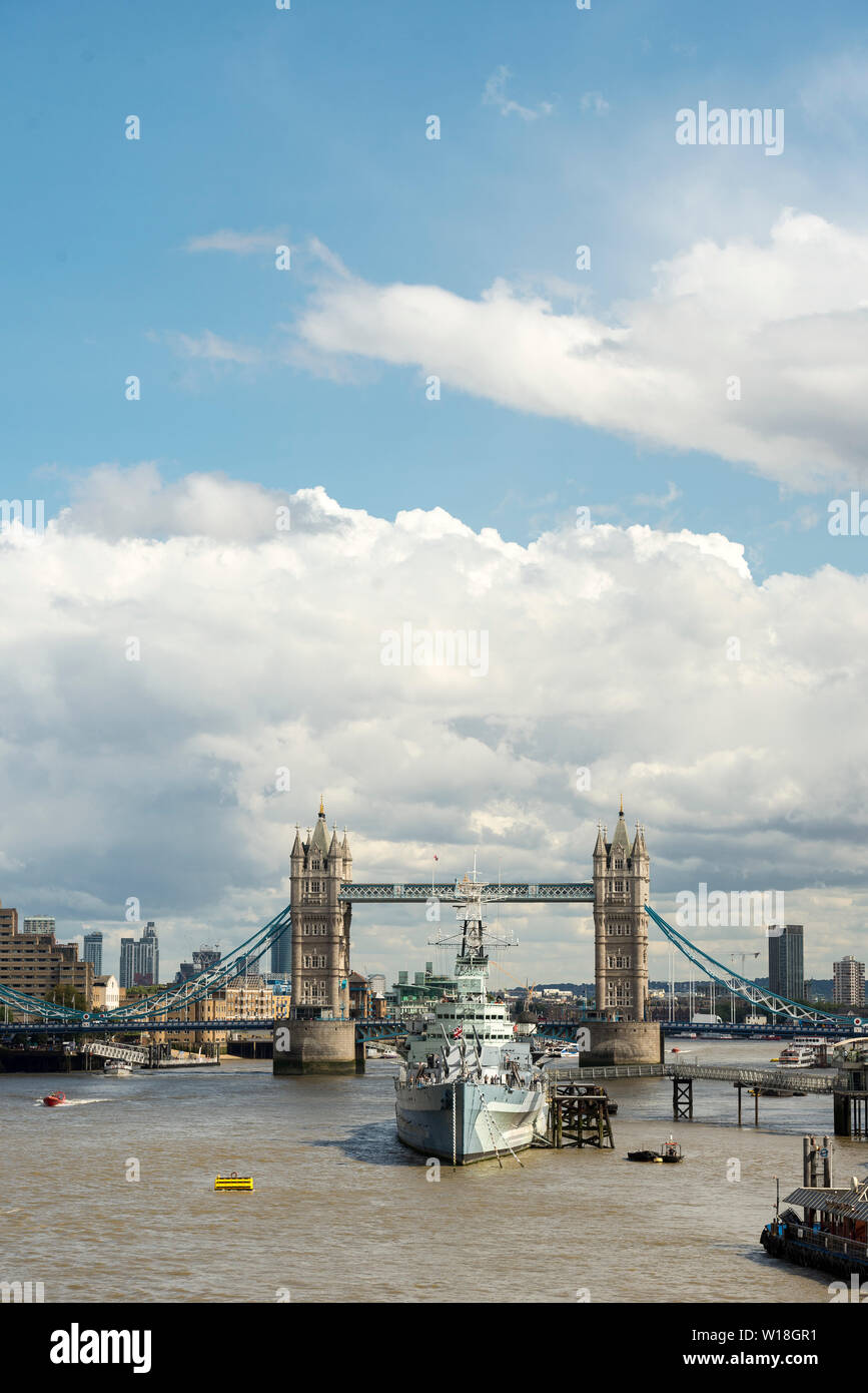 View looking east from London Bridge with Tower Bridge, HMS Belfast and The River Thames on a sunny day in the city Stock Photo