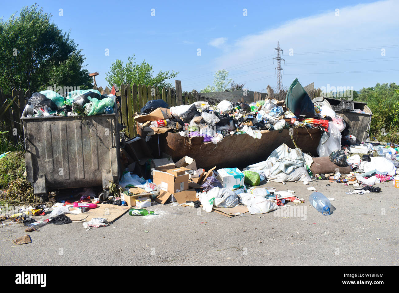 Overflowing garbage can in the city. Rubbish bins overflow with rubbish
