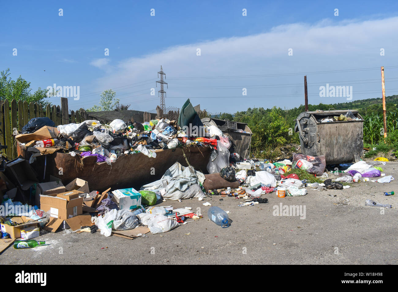 Overflowing garbage can in the city. Rubbish bins overflow with rubbish