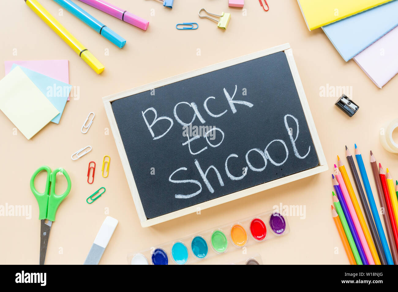Orange back to school flat lay with bright stationery. School supplies ...