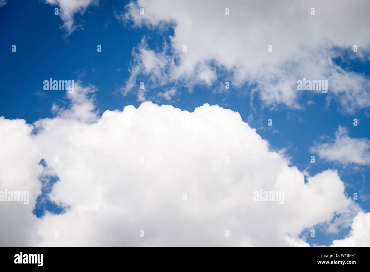 Beautiful white fluffy clouds on a deep blue sky background. Scenic sky ...