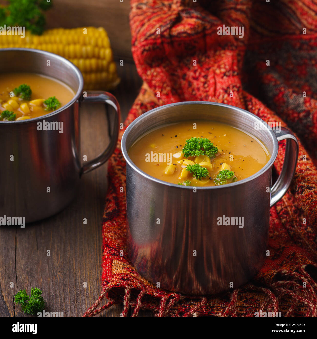 Pumpkin vegetable soup in a mug on a dark wooden background. Healthy autumn food Stock Photo