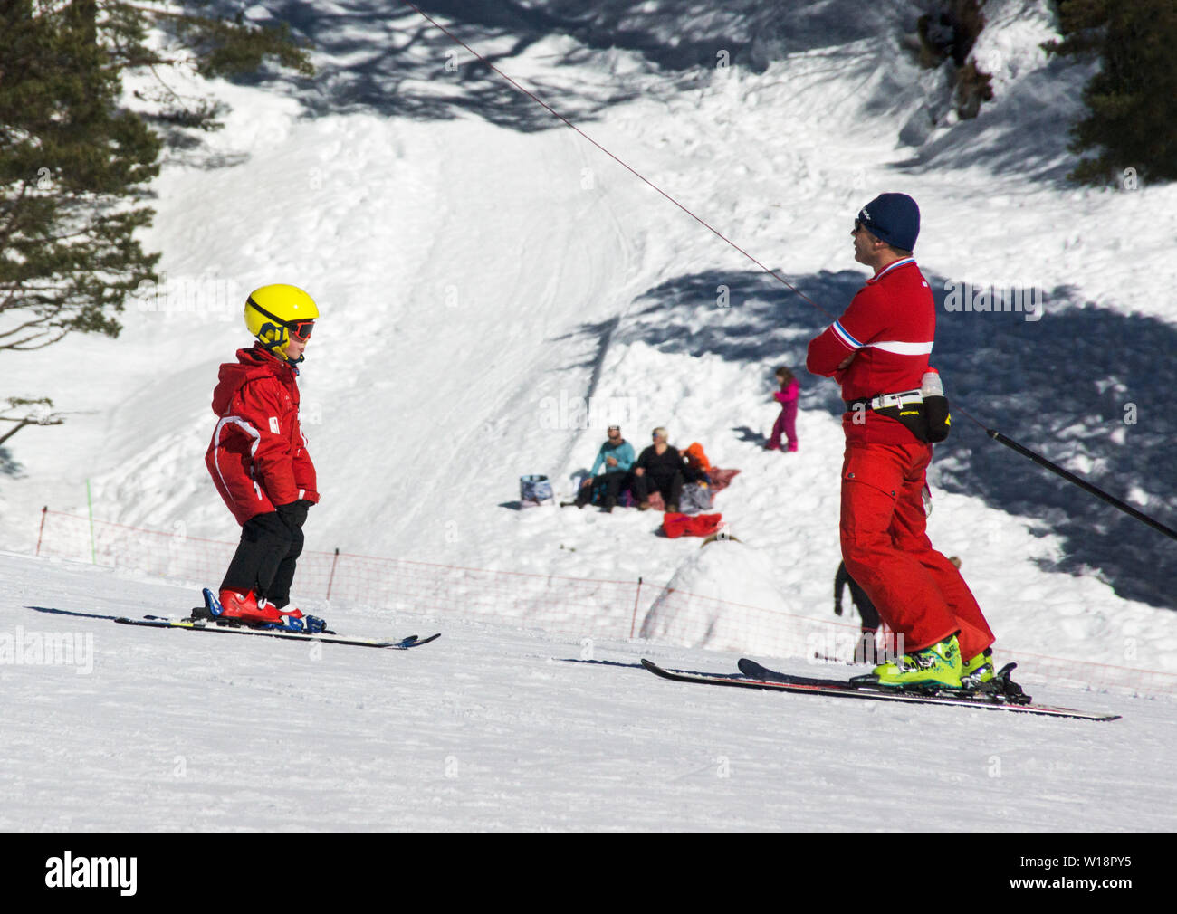 The central Pyrenees at Pont Espagne. Young boy learning to ski with the help of a qualified ski instructor. Stock Photo