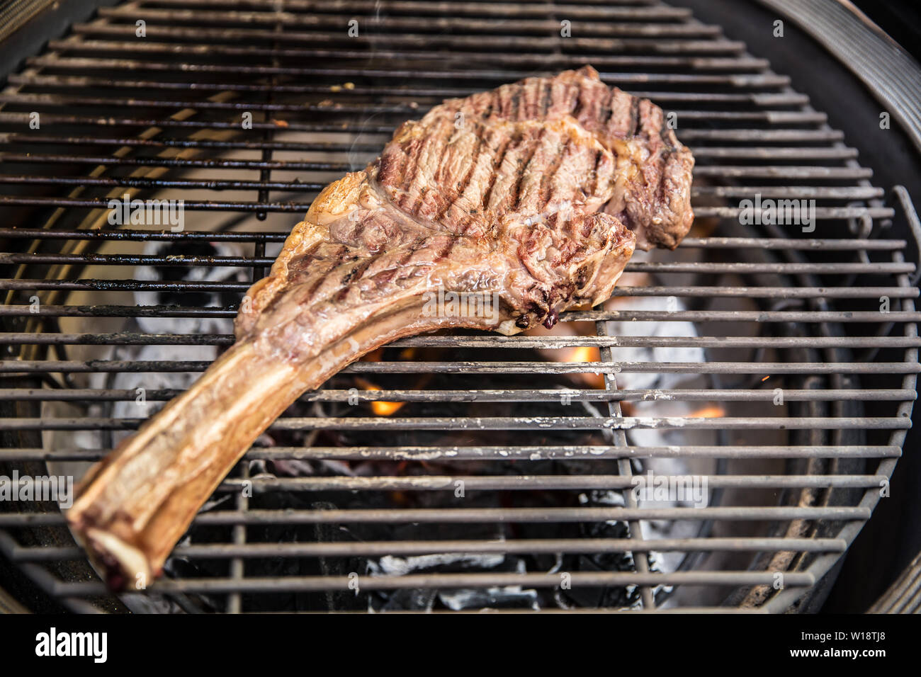 Beef tomahawk steak grilled on a grill closeup Stock Photo Alamy