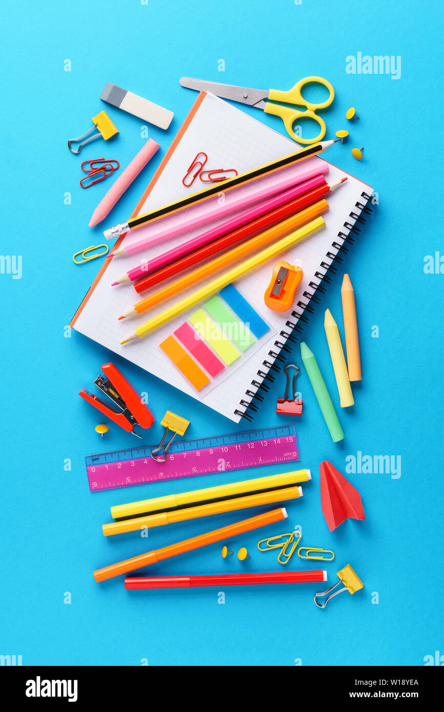 Set of various colorful school stationery and supplies on blue ...