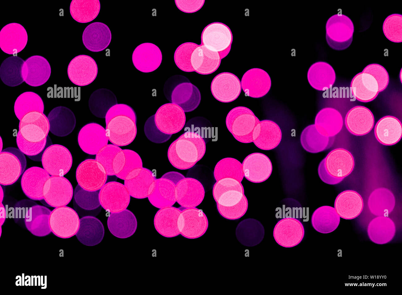 Unfocused abstract purple bokeh on black background. defocused and ...
