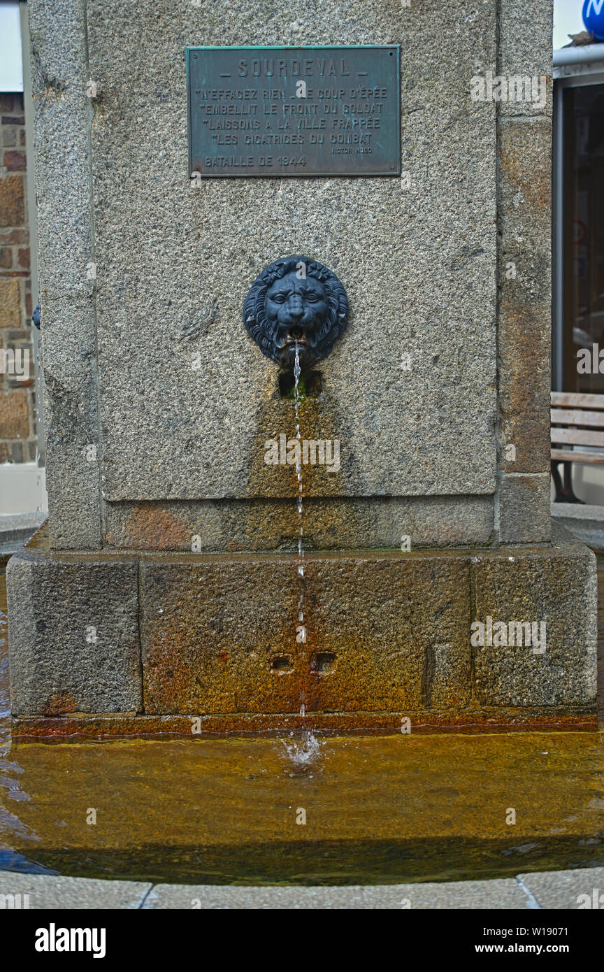 Water dripping from lions head at fountain in Surdeval Normandy France Stock Photo