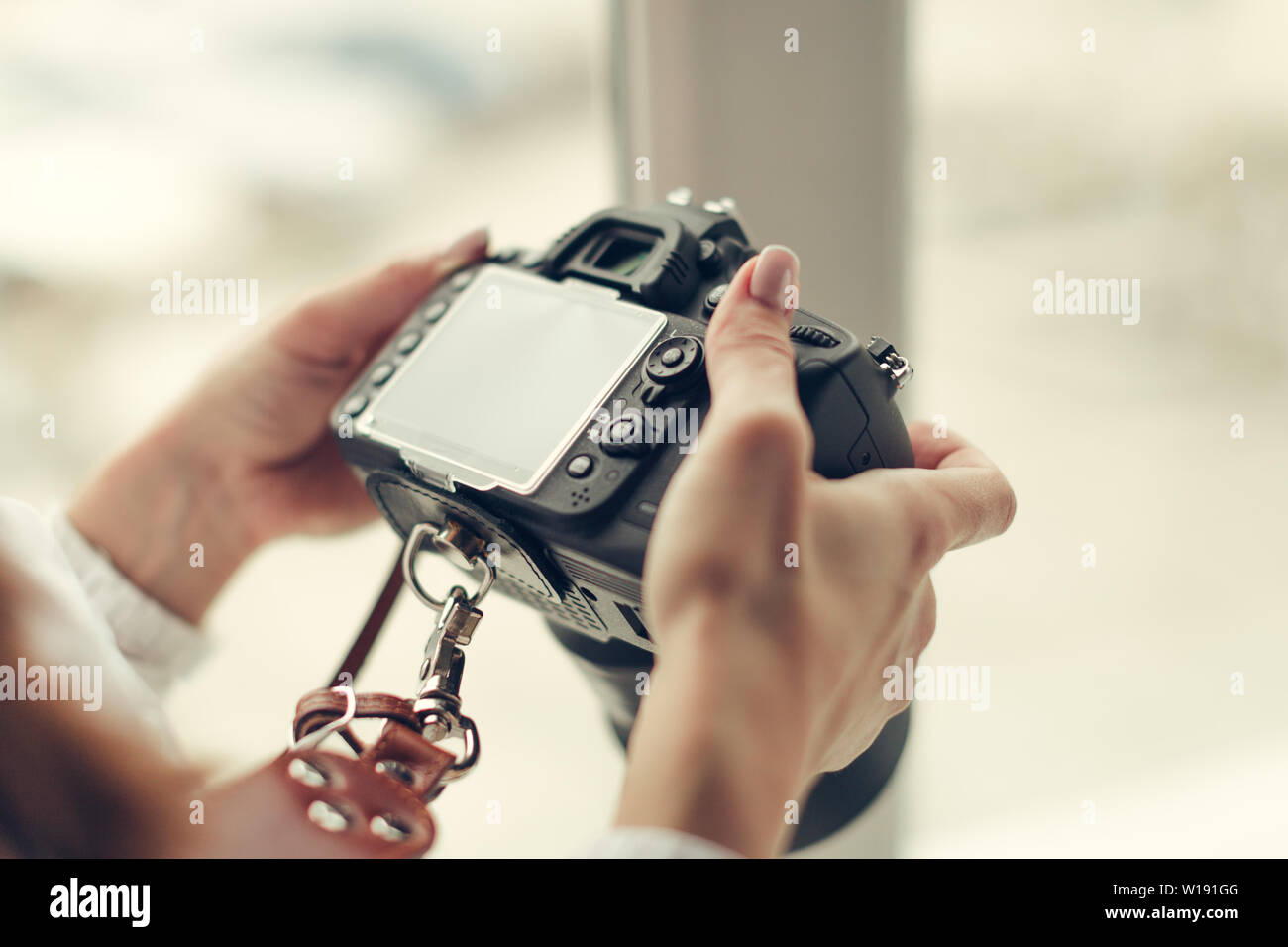 Pretty woman is a professional photographer with dslr camera Stock ...
