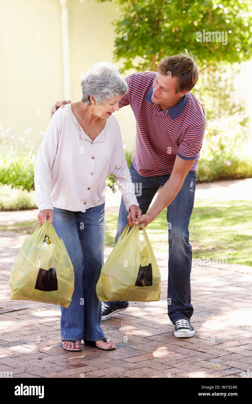 Helping elderly shopping bag hires stock photography and images Alamy