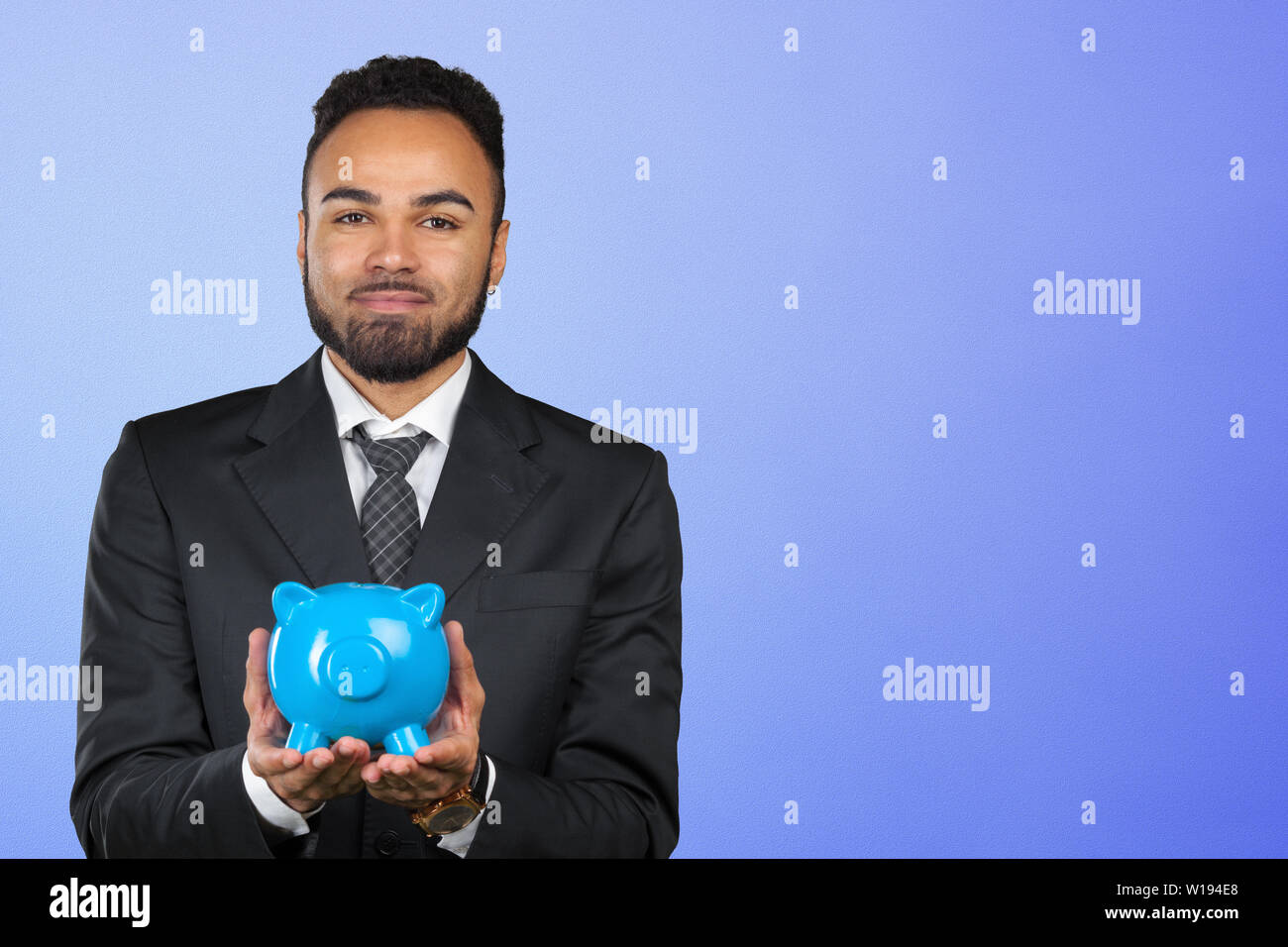 African American business man holding a piggy bank Stock Photo - Alamy