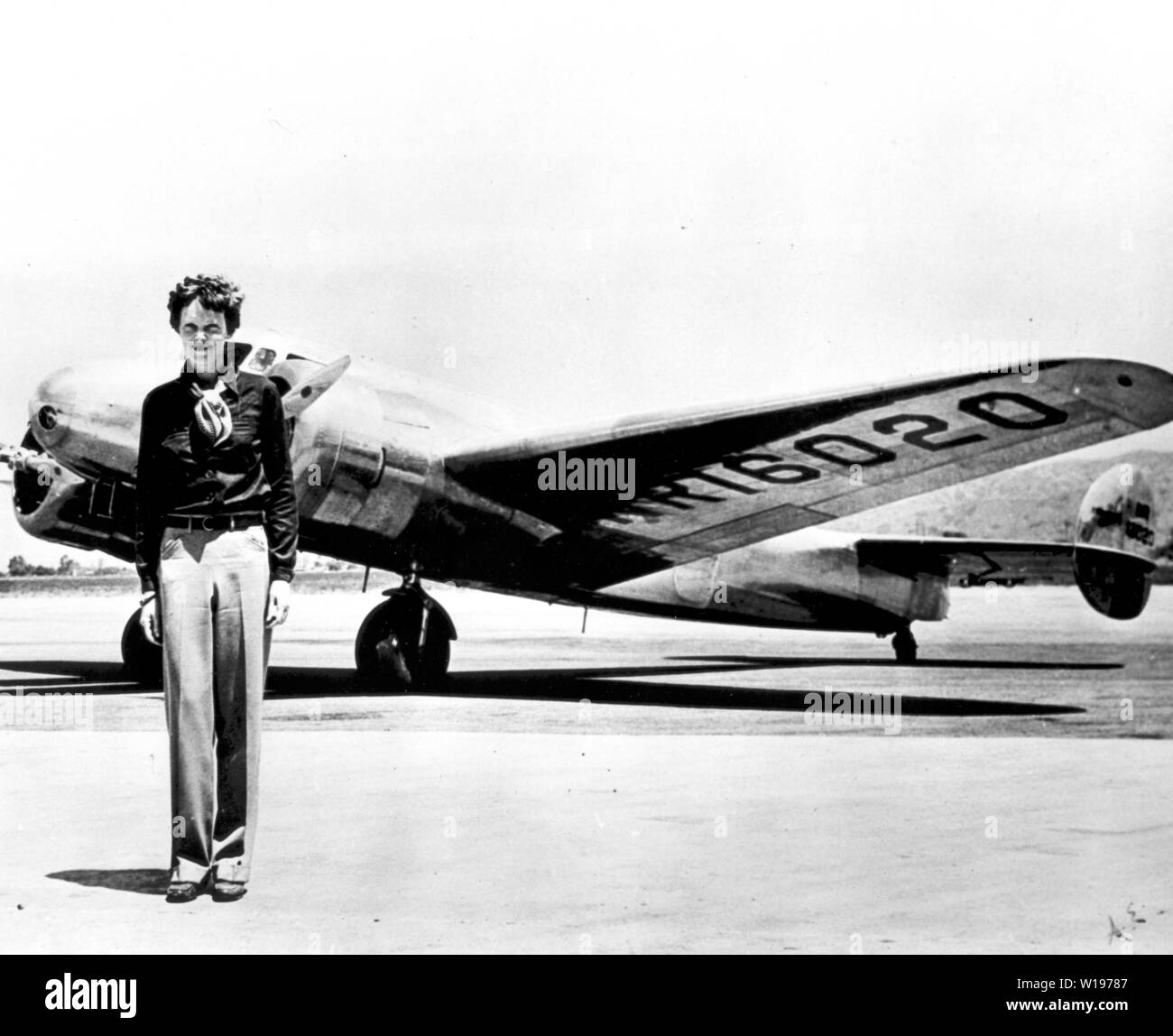 American aviation pioneer Amelia Earhart posing in front of the Lockheed Electra airplane, 1936. Image courtesy National Aeronautics and Space Administration (NASA). () Stock Photo