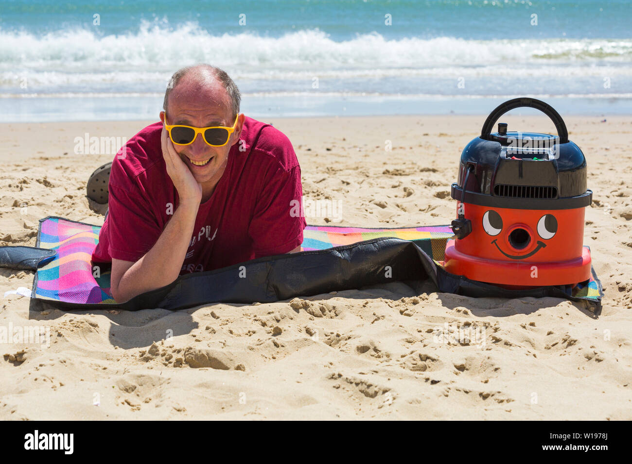 Bournemouth, Dorset, UK. 1st July 2019. Almost all workers are legally entitled to 5.6 weeks’ statutory leave entitlement paid holiday per year, but when was the last time Henry or Hetty had a day off? John took his hands off the nozzle, switched off the turbo charge and gave this hard working Hoover an afternoon off at Bournemouth beach. It also made a statement to make sure the beautiful Bournemouth, Christchurch & Poole beaches gain an awareness of the litter left behind every summer and that Henry and Hetty don't approve! Credit: Carolyn Jenkins/Alamy Live News Stock Photo