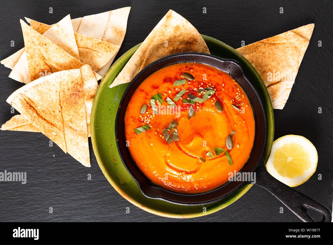 Healthy food concept Homemade pumpkin hummus in skillet iron pan with copy space Stock Photo