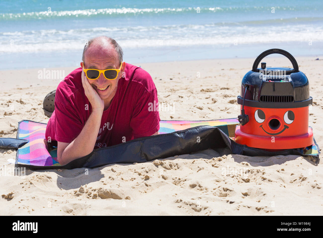 Bournemouth, Dorset, UK. 1st July 2019. Almost all workers are legally entitled to 5.6 weeks’ statutory leave entitlement paid holiday per year, but when was the last time Henry or Hetty had a day off? John took his hands off the nozzle, switched off the turbo charge and gave this hard working Hoover an afternoon off at Bournemouth beach. It also made a statement to make sure the beautiful Bournemouth, Christchurch & Poole beaches gain an awareness of the litter left behind every summer and that Henry and Hetty don't approve! Credit: Carolyn Jenkins/Alamy Live News Stock Photo