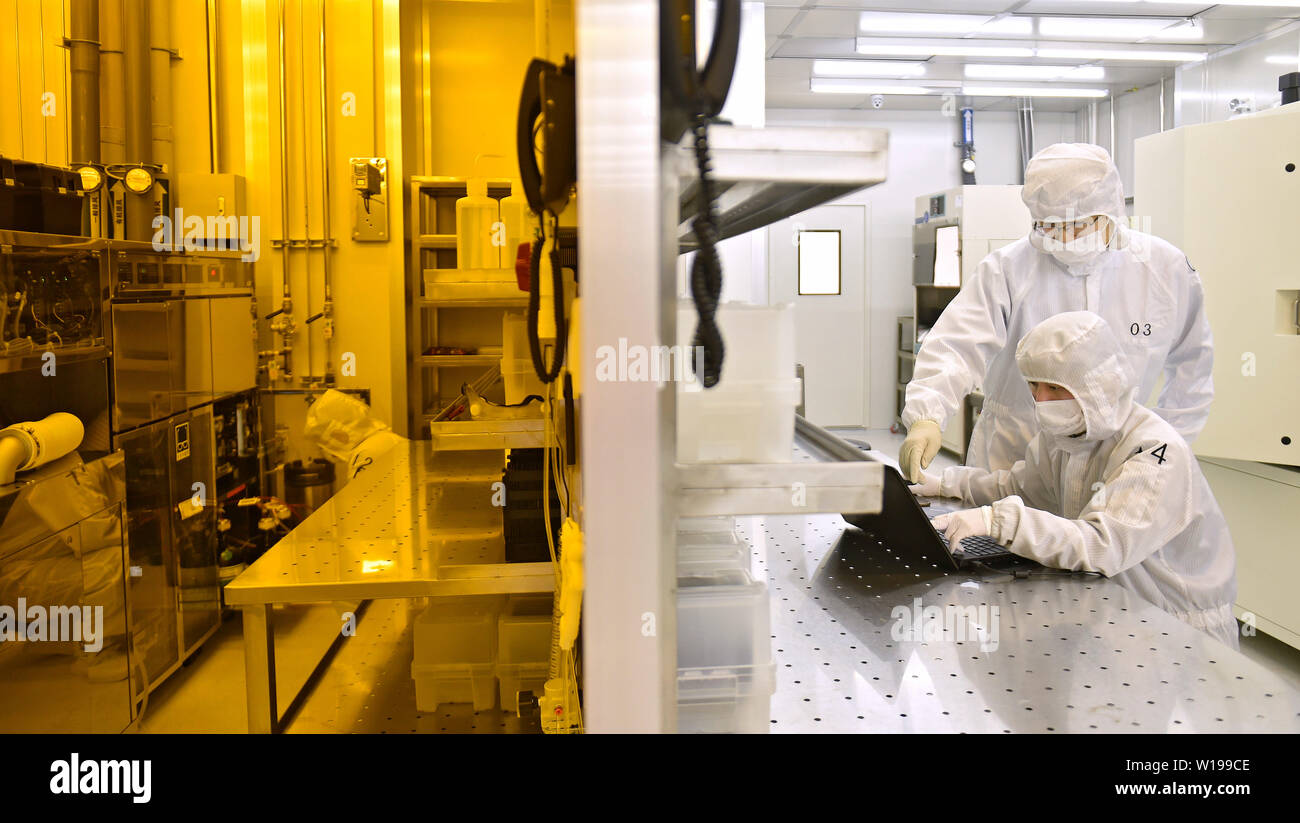 (190701) -- DALIAN, July 1, 2019 (Xinhua) -- Engineers work at Xinguan Technology, a semiconductor high-tech enterprise in Dalian, northeast China's Liaoning Province, April 1, 2019. The 2019 Summer Davos Forum is held from July 1-3 in northeast China's coastal city of Dalian. Established by the World Economic Forum in 2007, the forum is held annually in China, alternating between the two port cities of Dalian and Tianjin. Summer Davos helped Dalian reshape the landscape of regional economy and strengthen the port's trade with other markets. Dalian has become an international city and a showpi Stock Photo