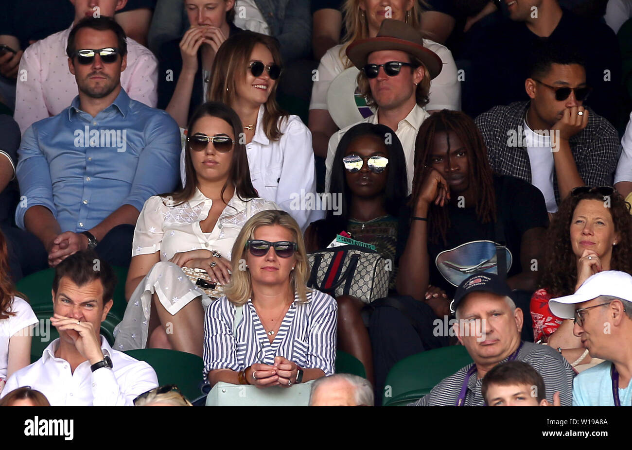 Amber Le Bon (centre left), Leomie Anderson and Lancey Foux (centre right) and Dougie Poynter and Maddy Elmer (centre back) in the stands on centre court on day one of the Wimbledon Championships at the All England Lawn Tennis and Croquet Club, Wimbledon. Stock Photo