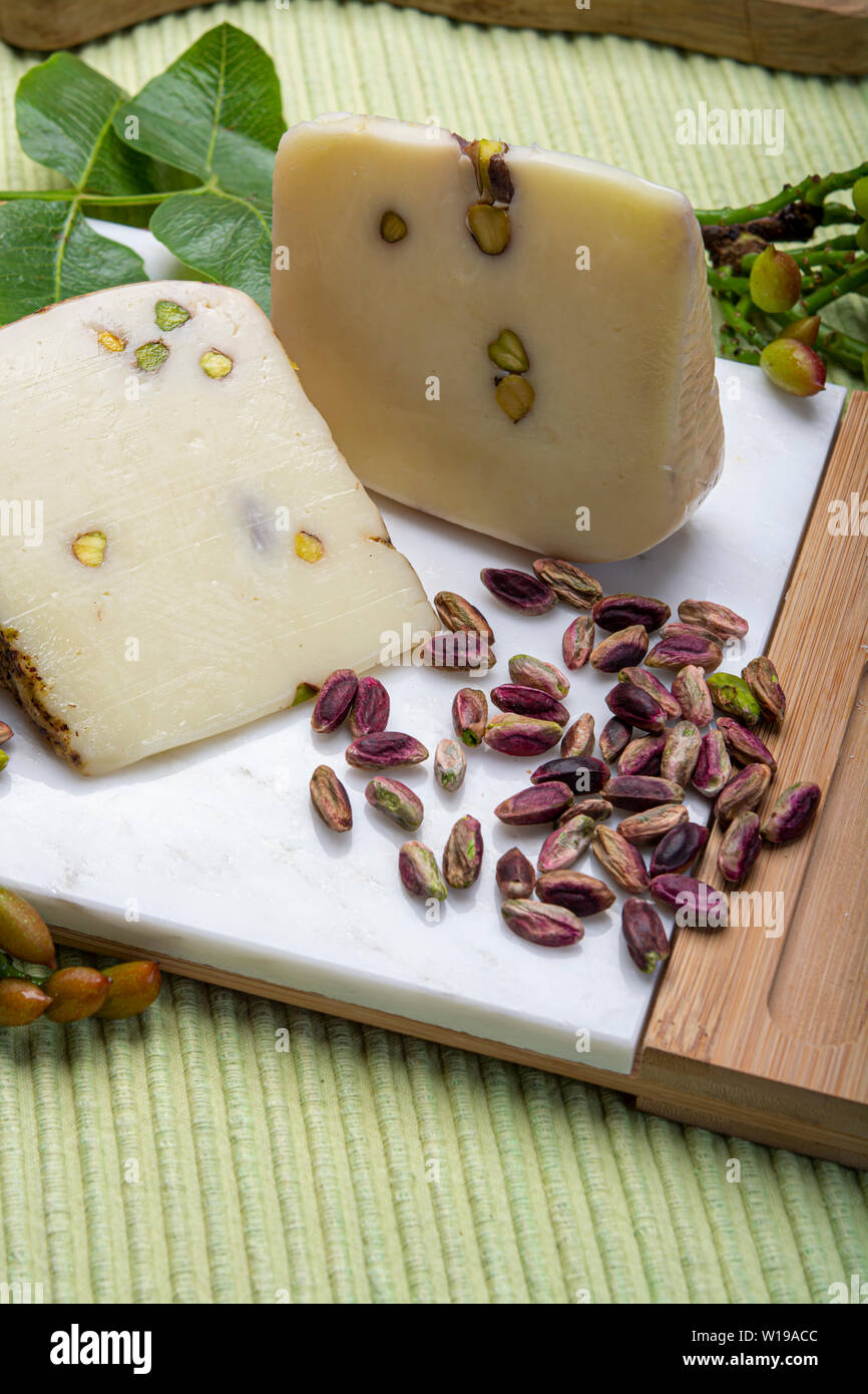 Cheese collection, Italian provolone or provola cheese made in Sicily with  tasty green Bronte pistachio nuts served on white marble plate close up  Stock Photo - Alamy