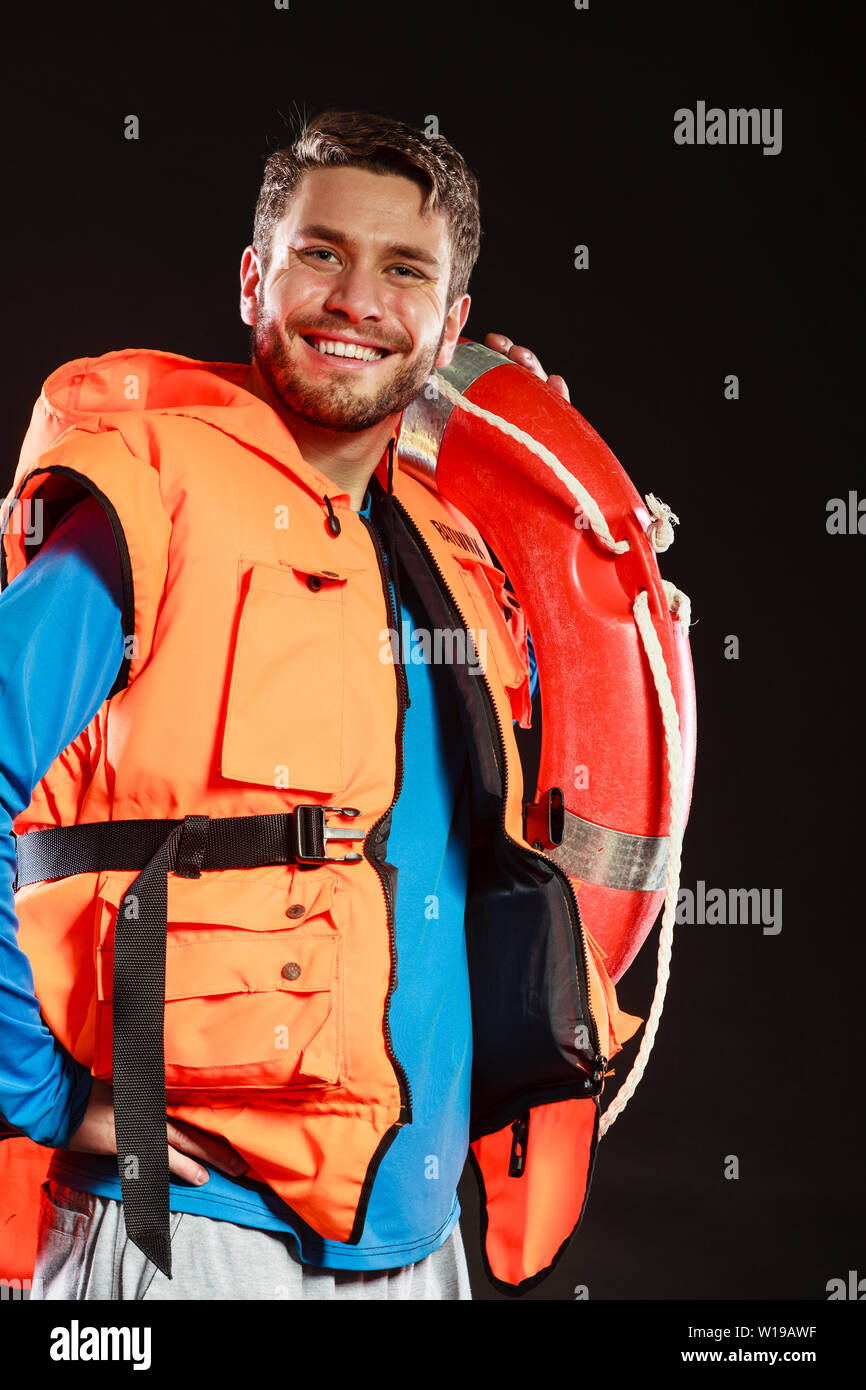 Lifeguard in life vest jacket with ring buoy lifebuoy. Man supervising  swimming pool water on black. Accident prevention Stock Photo - Alamy