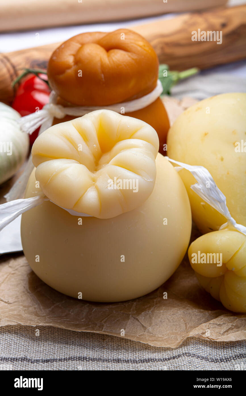 Cheese collection, Italian provolone or provola caciocavallo hard and  smoked cheeses in teardrop form served on old paper close up Stock Photo -  Alamy