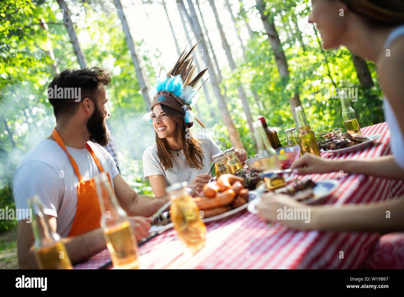 Group of happy friends having a barbecue party in nature Stock Photo ...