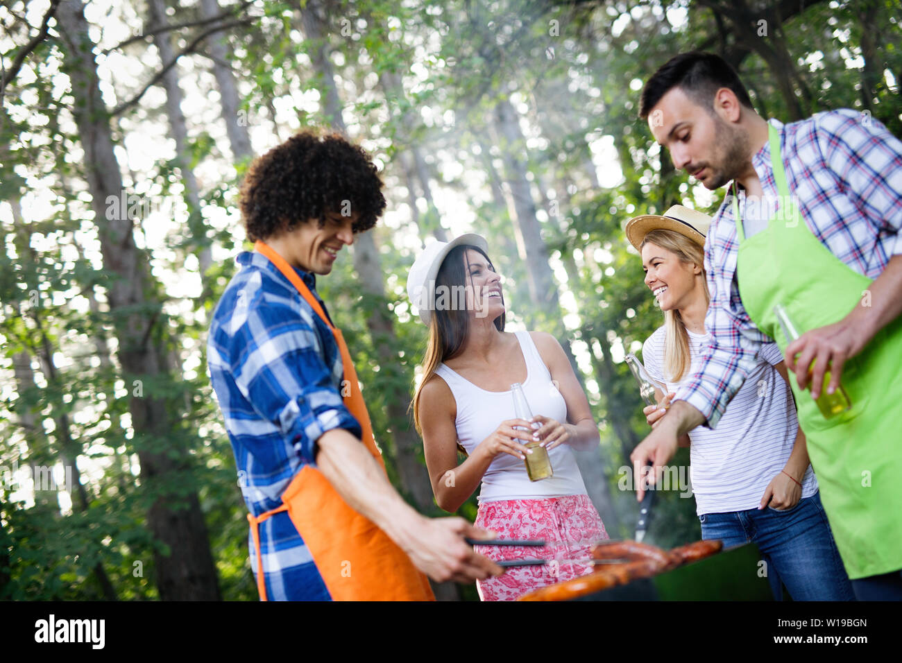 Group of friends having a barbecue and grill party in nature Stock ...