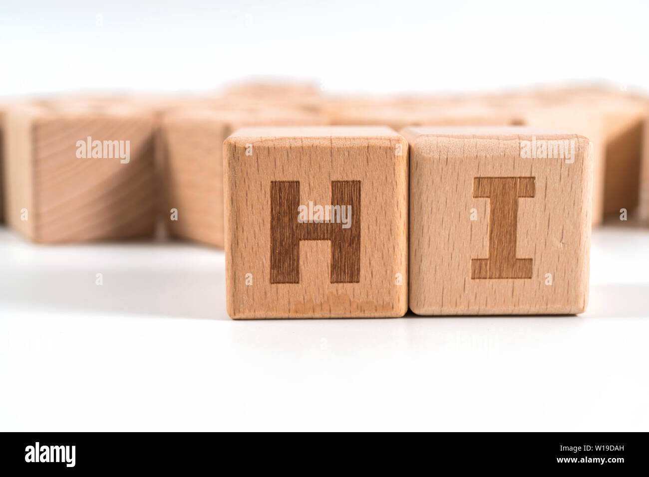 word HI on wood cube dices on white background. Stock Photo