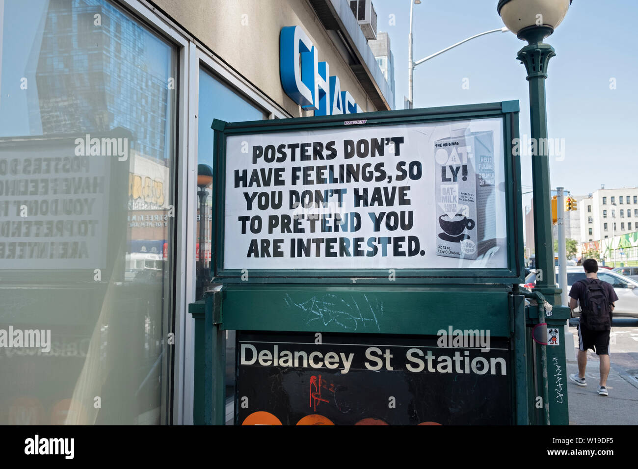 A funny clever advertisement for Oatly oak milk displayed above a subway entrance on the Lower East Side of Manhattan, New York City. Stock Photo
