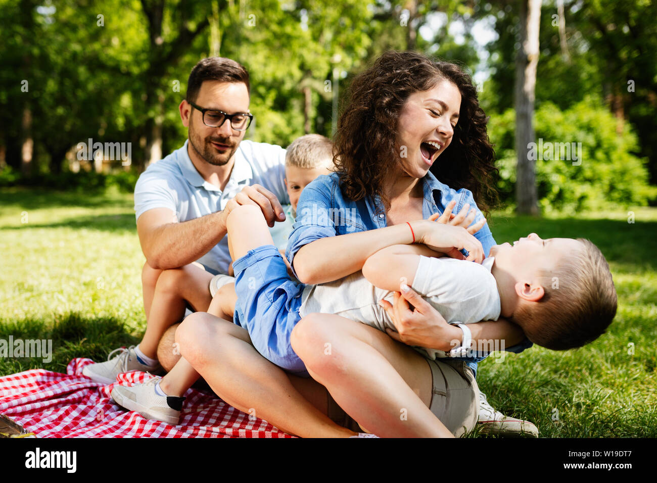 Young family with children having fun in nature Stock Photo