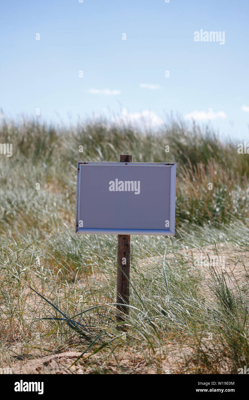 Blank notice board on a beach in Norfolk. Stock Photo